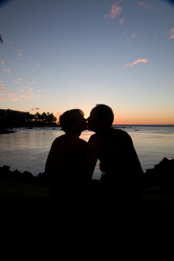A kissing couple enjoys the ease of a great relationship
