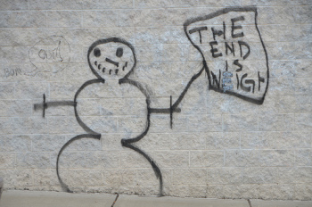 Graffiti of a snowman holding a sign that says "THE END IS NEIGH"