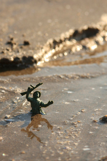 a small toy soldier is stuck in quicksand